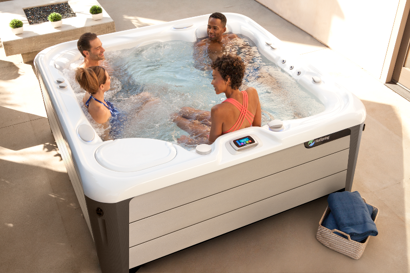 The spacious 5-seater Highlife® Aria™ (seen here in Alpine White shell and Sand Stone cabinet) | HotSpring Spas